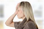 Woman with headache holding her hand to the head