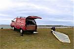 a van and windsurfer getting equipment ready on the beach in the maharees county kerry ireland