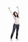 Happy young woman with arms up, isolated against a white background