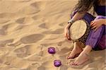 Girl with a djembe enjoying  on a sunny beach