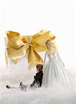 Wedding cake figures with gold ribbon gift on white