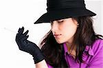 Portrait of a beautiful brunette young woman with black hat, gloves and cigarette