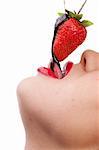 Beautiful girl eating a fresh red strawberry with chocolate sauce