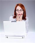 Red-haired girl with white notebook. Studio shot.