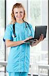 Beautiful young doctor with laptop and stethoscope in hospital