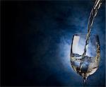 Photo of white wine inside a wine glass with abstract background