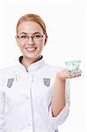 A young doctor with a dental jaw on a white background