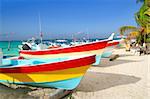 colorful tropical boats beached in the sand Isla Mujeres Mexico