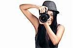 A pretty asian girl taking photos with an SLR and smiling.