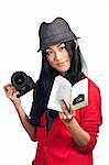 Pretty asian girl reading an instruction guide for an SLR camera.