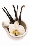 mortar with vanilla pods and flower