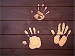 The hand prints of mud on a wooden board