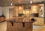 Kitchen in modern home or apartment with sleek warm wood cabinetry