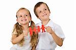 Kids holding paper people family and smiling - happy family concept