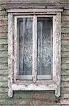 Old window on a aged wooden wall