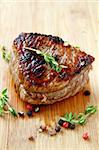 juicy sirloin beef with branches of thyme covered in pepper