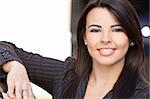 Outdoor portrait of a beautiful young Latina Hispanic woman or businesswoman smiling