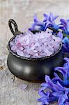 Spa still life .Bath lilac salt, towel and  flowers