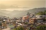 City sunset scenery with buildings on hill and harbor far away in Jiufen(Jioufen), Taiwan, Asia.