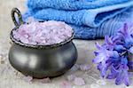 Spa still life .Bath lilac salt, towel and  flowers