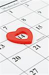 Heart shape marker on calendar page showing February 14 Valentine's Day