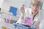 doctor student  female researcher holding up a test tube in chemistry bright labaratory