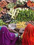 Indian women selling fruit and vegetables at a street market during the annual Camel Fair in Pushkar, Rajasthan, India