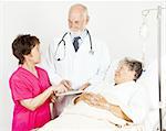 Nurse and doctor discussing a hospital patient's chart.
