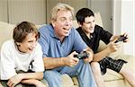 Uncle plays video games with his nephews.  Could also be father.
