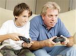 Uncle and nephew (or father and son) playing video games together.