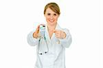 Smiling  medical doctor woman pointing finger on calculator isolated on white