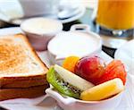 Breakfast with orange juice and fresh fruits on table