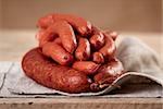 closeup of smoked sausages on wooden table