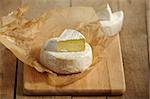 camembert and brie cheese on wooden cutting board