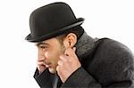 Portrait of a man with bowler hat  hiding from the cold
