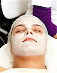 Woman with a beauty mask on her face in a salon