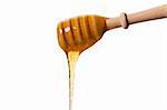 honey falling from a honey dipper on white background