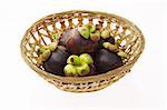 Mangosteens in basket isolated on white background