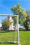 Church of Annunciation of Blessed Virgin Mary (Sydoriv village, Ternopil region, Ukraine, Built in 1726-1730) and neglected football field.