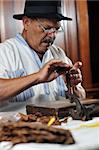 older senior man making luxury handmade cuban cigar