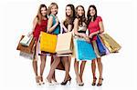 Five attractive young women with shopping on white background