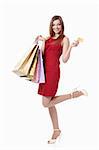 Young girl with bags and credit card on a white background