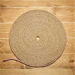 Twisted rope on wooden background