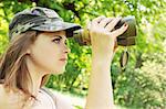 portrait of girl which looks into the binoculars