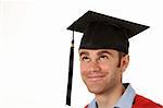 portrait of a young man looking up to his graduation hat