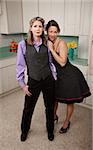 Two happy women standing together in kitchen