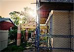 residential reconstruction home framing against evening sky