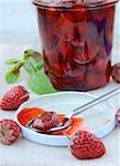 homemade strawberry jam with whole berries on the table