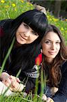 Portrait of a smiling mother and teenage daughter in park