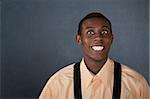 Happy young Black man on gray background with big grin